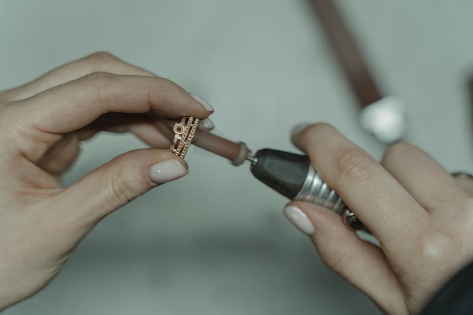 A ring held against a small rotary polishing tool.